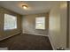 Bright bedroom with carpeted floor and two windows at 6358 Joanna St, Lithia Springs, GA 30122