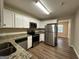 Kitchen with stainless steel appliances and granite countertops at 4778 Glenwood Rd, Decatur, GA 30035