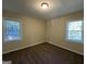 Bright bedroom with neutral walls and carpet, featuring two windows with blinds at 4778 Glenwood Rd, Decatur, GA 30035