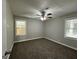 Well-lit bedroom with plush carpeting and ceiling fan at 3564 Glenwood Rd, Decatur, GA 30032