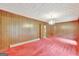 Dining room with red carpet and wood paneling at 115 Bernhard Rd, Fayetteville, GA 30215