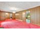 Spacious dining room with wood paneling and red carpet at 115 Bernhard Rd, Fayetteville, GA 30215