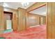 Living room with red carpet and wood paneling at 115 Bernhard Rd, Fayetteville, GA 30215