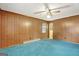 Bedroom featuring wood paneling and teal carpet at 115 Bernhard Rd, Fayetteville, GA 30215