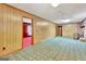 Spacious living room with wood paneling, a fireplace, and access to other rooms at 115 Bernhard Rd, Fayetteville, GA 30215