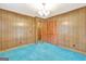 Bedroom with wood paneling and teal carpet at 115 Bernhard Rd, Fayetteville, GA 30215