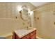 Bathroom with shower stall, vanity, and vintage wallpaper at 115 Bernhard Rd, Fayetteville, GA 30215