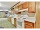 Kitchen boasts wood cabinets, an electric range, and a microwave at 115 Bernhard Rd, Fayetteville, GA 30215