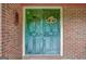 Distressed teal front door with decorative wreath at 115 Bernhard Rd, Fayetteville, GA 30215