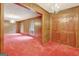 Dining room with wood paneling, red carpet, and chandelier at 115 Bernhard Rd, Fayetteville, GA 30215