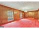 Spacious dining room with wood paneling and chandelier at 115 Bernhard Rd, Fayetteville, GA 30215