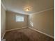 Cozy carpeted bedroom with neutral walls and a window at 3850 Bright Star Rd, Douglasville, GA 30135