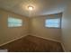 Spacious bedroom with neutral carpeting and two large windows at 3850 Bright Star Rd, Douglasville, GA 30135