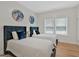 Twin bedroom with navy blue headboard and hardwood floors at 2147 Mcafee Rd, Decatur, GA 30032