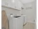 Bright laundry room with washer, dryer, and cabinets at 2147 Mcafee Rd, Decatur, GA 30032