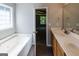 Bathroom with garden tub, double vanity, and access to bedroom at 5120 Roxton Ln, Douglasville, GA 30135
