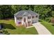 Aerial view of a two-story house with a red door and attached garage at 5120 Roxton Ln, Douglasville, GA 30135