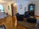 Living room area featuring hardwood floors, leather furniture, and a view into the dining and kitchen areas at 1723 Fort Valley Sw Dr, Atlanta, GA 30311