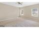 Well-lit bedroom with two windows, ceiling fan, and carpet at 100 Dogwood Trail Dr, Stockbridge, GA 30281