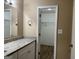 Bathroom with granite countertop, white cabinets, and walk-in closet at 2929 Stratford Mill Rd, Lithonia, GA 30038