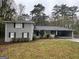 Gray brick house with attached carport and landscaping at 2929 Stratford Mill Rd, Lithonia, GA 30038
