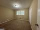 Spacious bedroom with neutral walls, carpet, and a double window at 2929 Stratford Mill Rd, Lithonia, GA 30038