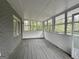 Cozy screened porch with wood flooring and wooded views at 2929 Stratford Mill Rd, Lithonia, GA 30038