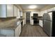 Modern kitchen with granite countertops, white cabinets, and stainless steel appliances at 2929 Stratford Mill Rd, Lithonia, GA 30038