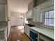 Bright kitchen with white cabinets, hardwood floors, and a chandelier at 275 Allie Dr, Mcdonough, GA 30252