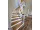 Elegant curved staircase with wooden handrail and white risers at 275 Allie Dr, Mcdonough, GA 30252