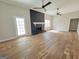 Living room with hardwood floors, fireplace, and ceiling fans at 275 Allie Dr, Mcdonough, GA 30252