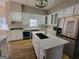 Spacious kitchen featuring white cabinets, stainless steel appliances, and a large island at 275 Allie Dr, Mcdonough, GA 30252