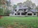 The back of the house has a screened porch and a large grassy backyard at 275 Allie Dr, Mcdonough, GA 30252