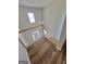 Elegant curved staircase with hardwood floors and a chandelier at 275 Allie Dr, Mcdonough, GA 30252