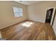 Well-lit bedroom featuring hardwood floors and access to another room at 275 Allie Dr, Mcdonough, GA 30252