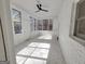 Bright sunroom with white brick walls and marble-look tile floors at 275 Allie Dr, Mcdonough, GA 30252