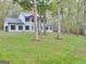 Two story house with white exterior, black accents, and a spacious yard at 275 Allie Dr, Mcdonough, GA 30252