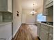 Kitchen and dining area with hardwood floors and white cabinets at 275 Allie Dr, Mcdonough, GA 30252