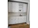 Built-in wet bar with white cabinets and quartz countertop at 275 Allie Dr, Mcdonough, GA 30252