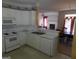 White kitchen with appliances, and view to living room at 440 Falling Leaf Ct, Mcdonough, GA 30253