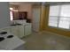 Kitchen features white cabinets, appliances, and adjacent dining area at 440 Falling Leaf Ct, Mcdonough, GA 30253