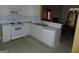White kitchen with appliances and view of living room and dining area at 440 Falling Leaf Ct, Mcdonough, GA 30253