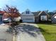 Ranch style home with brick and vinyl siding, two-car garage, and landscaped yard at 440 Falling Leaf Ct, Mcdonough, GA 30253