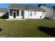 Back exterior view of home with screened porch and patio at 440 Falling Leaf Ct, Mcdonough, GA 30253