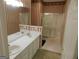 Bathroom with double vanity, shower, and striped wallpaper at 440 Falling Leaf Ct, Mcdonough, GA 30253