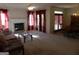 Living room with fireplace, and ample natural light, adjacent to dining area at 440 Falling Leaf Ct, Mcdonough, GA 30253