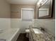 Updated bathroom with granite countertop, white tile, and a bathtub at 4310 Bakers Ferry Sw Rd, Atlanta, GA 30331