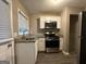 Updated kitchen features granite countertops, stainless steel appliances, and white cabinets at 4310 Bakers Ferry Sw Rd, Atlanta, GA 30331