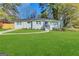 Modern white ranch house with a red door and manicured lawn at 3168 Mcafee Rd, Decatur, GA 30032