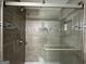 Large walk-in shower with gray tile and glass enclosure at 3168 Mcafee Rd, Decatur, GA 30032
